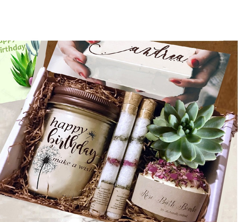 Custom Birthday Gift Box, Gift Ideas, Happy Birthday Gift Box, Happy Birthday Gift Basket, Birthday Gifts Ideas, Birthday Gifts For Her - A gift box containing a jar candle with "happy birthday" written on it, two tubes of bath salts, a bath bomb labeled "Rose" with dried petals, and a small green succulent plant, all nestled in brown shredded paper. Naturally GiftedNY